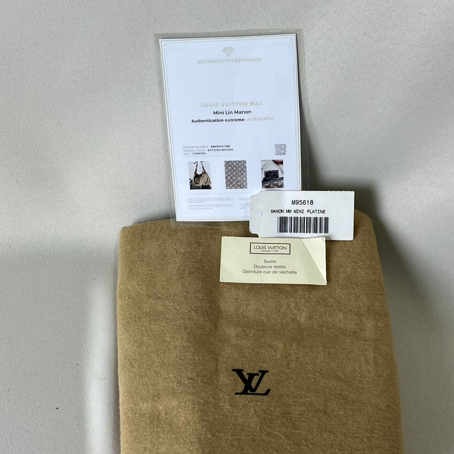 Louis Vuitton	Mini Lin Manon MM Grey Metallic Leather Trim