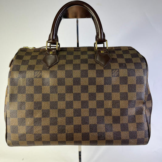 Louis Vuitton	Speedy Bag in the Damier Ebene Canvas